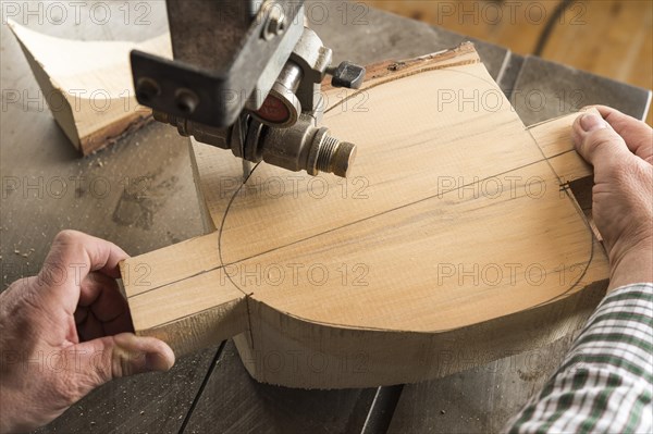 Cutting a wooden block using a band saw