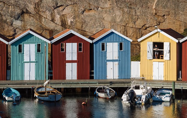 Boats and colourful boathouses in the harbour of Smogen