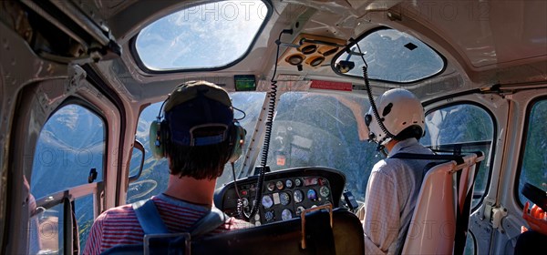 Helicopter cockpit with pilot and passenger in flight to Mount Cook