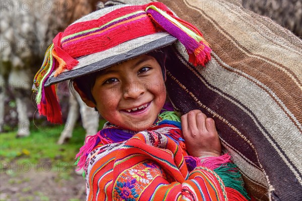 Indio Boy in traditional costume with poncho and hat