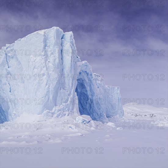 Iceberg in a frozen fjord