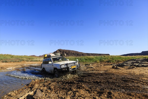 SUV crossing water