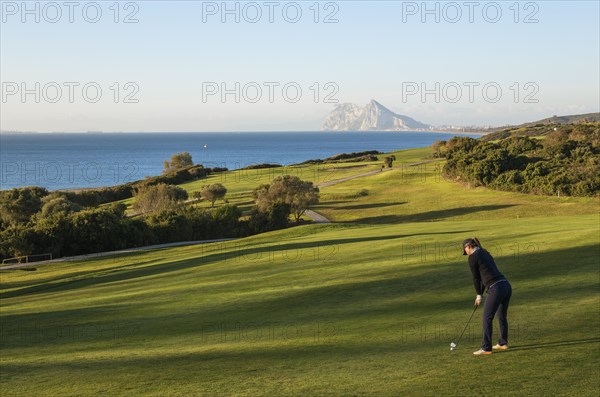 Golfer at La Alcaidesa Golf Resort with Mediterranean Sea and Rock of Gibraltar