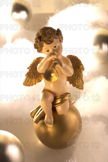 Ceramic angel figure plays trumpet