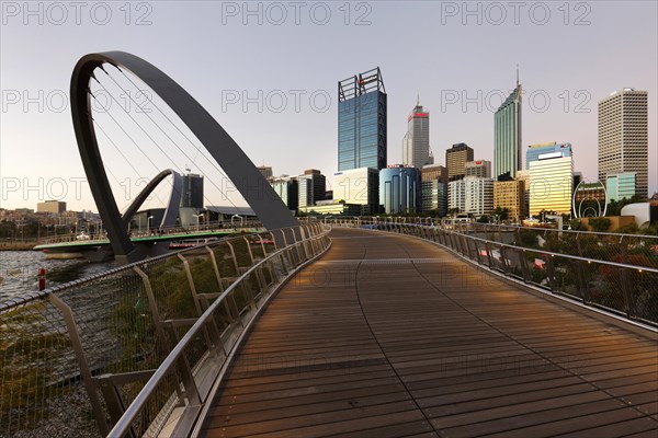 Foot bridge with city skyline