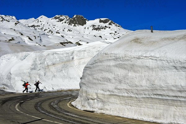 Two skiers in front of high snow walls