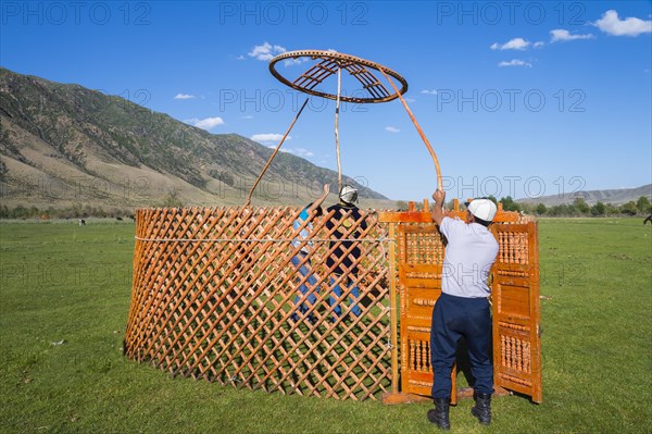Kazakh men putting up a yurt