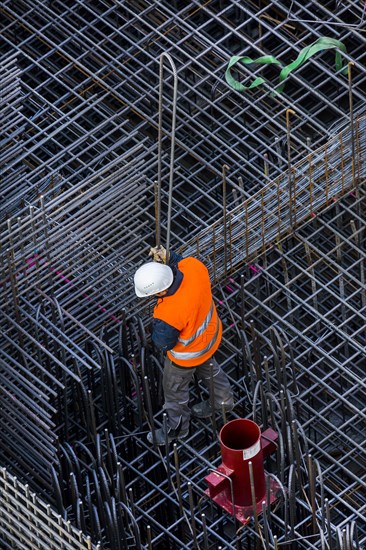 Construction workers processing reinforcing steel for reinforced concrete ceiling