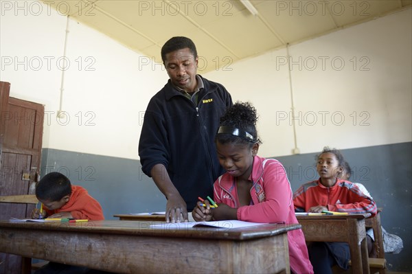 Teacher helping a female student