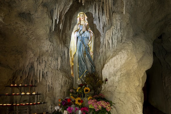 Lourdes grotto with a statue of the Virgin Mary