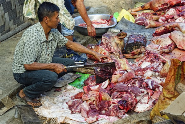 Indian Man cutting meat at the Hornbill Festival