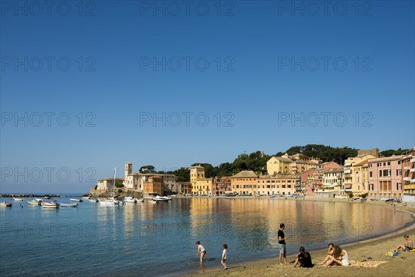 People on the beach in the bay Baia del Silenzio