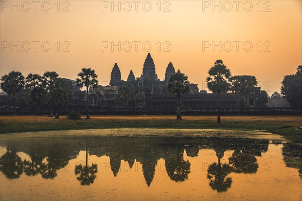 Temple complex of Angkor Wat reflected in the water basin