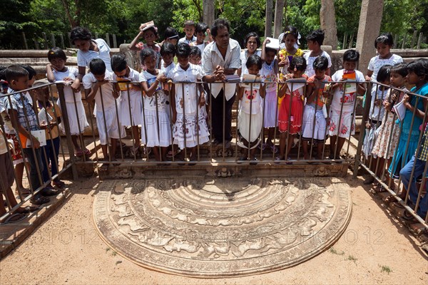 Native people observing moonstone at Mahasena Palace