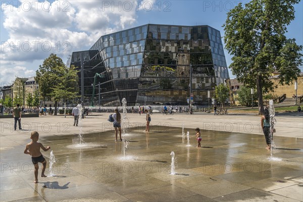 Playing children at the fountain in front of the university library Freiburg im Breisgau