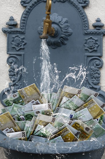 Counterfeit money in fountain with water running