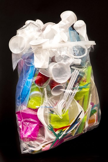 Garbage bag filled with disposable crockery