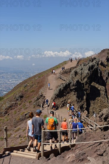 Tourists on a path along the crater edge