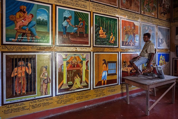 Singhalese man restoring murals