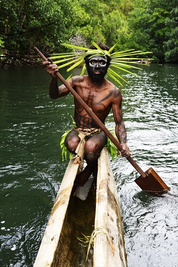 Korafe-Man paddling in a dugout boat