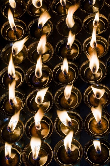 Tibetan butter lamps with burning flames