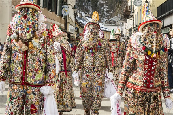 Ausseer Flinserl disguised people in costume with face masking or Gugl and hat