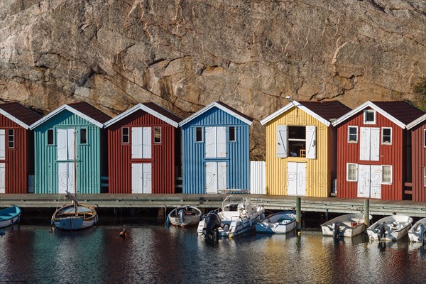 Boats and colourful boathouses in the harbour of Smogen