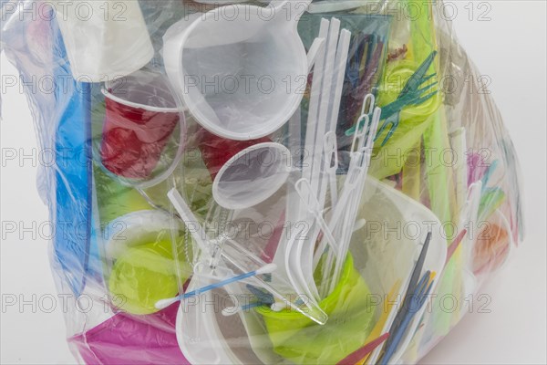 Garbage bag filled with disposable crockery