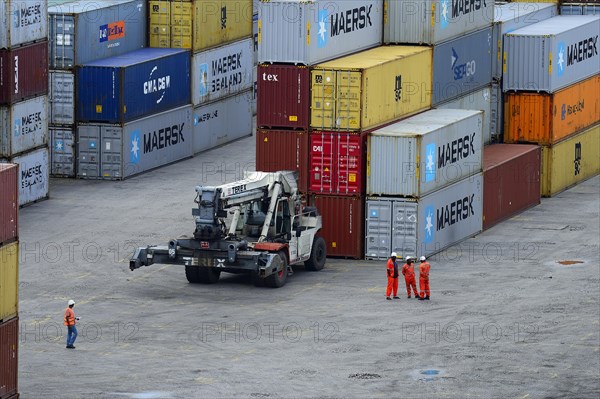 Stacked containers and dockers in port area