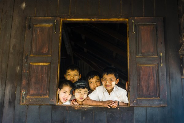 School children look curiously out of the window