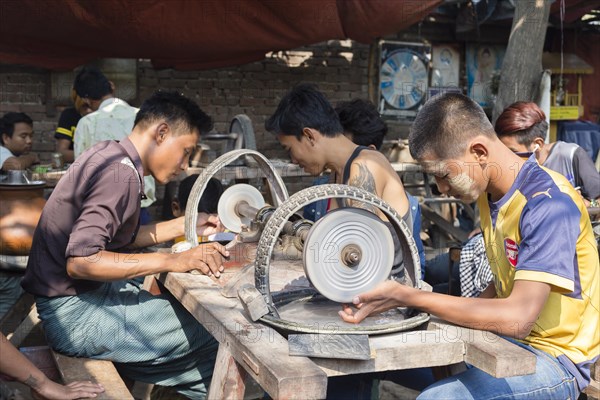 Grinding jade stones on a machine