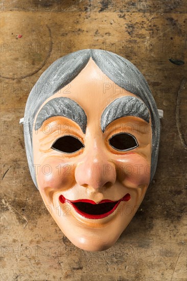 Painted wooden mask on a workbench