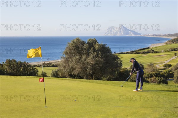 Golfer putting on green