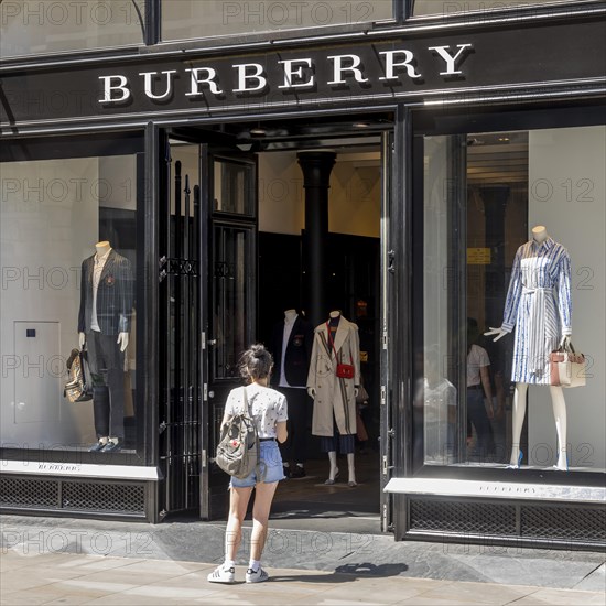 Woman in front of clothing store Burberry