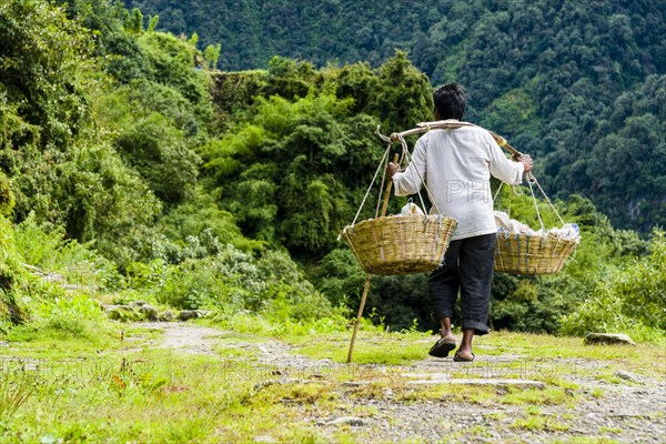 Man is carrying goods along a track