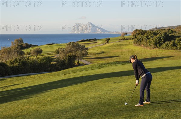 Golfer at La Alcaidesa Golf Resort with Mediterranean Sea and Rock of Gibraltar