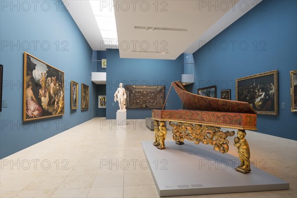 Exhibition space with paintings and harpsichord