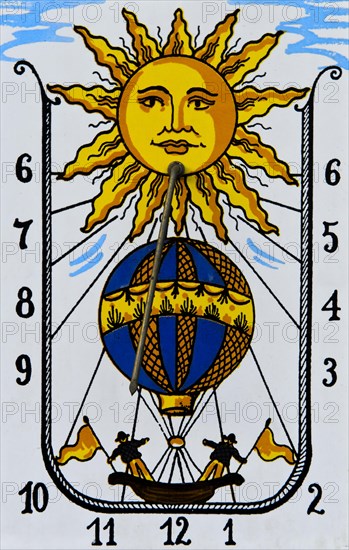 Sundial with sun and hot air balloon