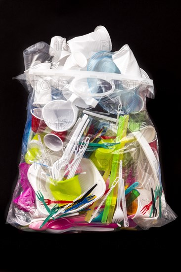 Garbage bag filled with disposable crockery