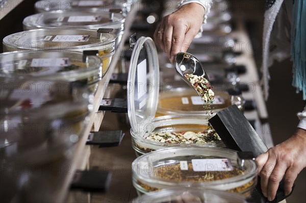 Spice mixture being poured into paper bag