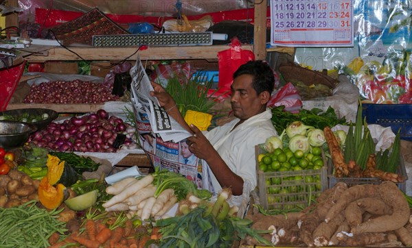 Seller reading newspaper