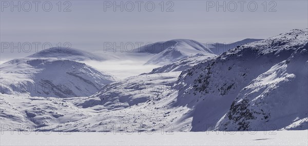 Panoramic view of mountains of Baffin seen from frozen fjord