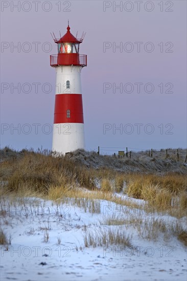 Red and white striped lighthouse List East in the dunes