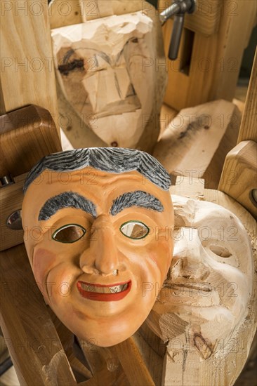 Painted wooden mask on a workbench