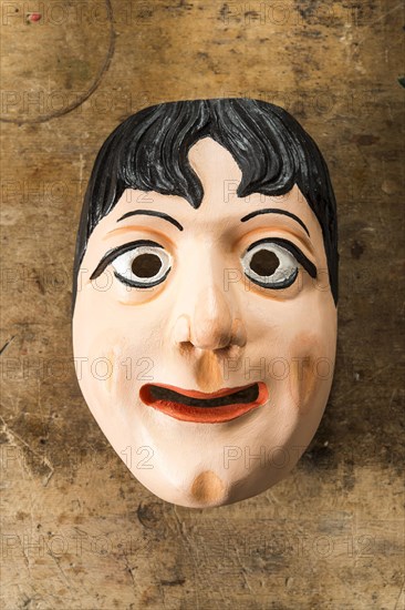 Painted wooden mask on a workbench