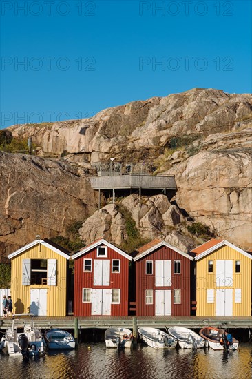 Boats and colourful boathouses in the harbour of Smogen