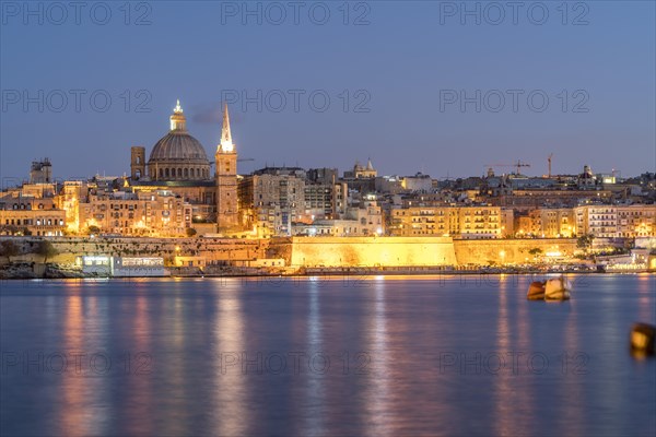 City view with St. Paul's Pro Cathedral and Carmelite Church at dusk