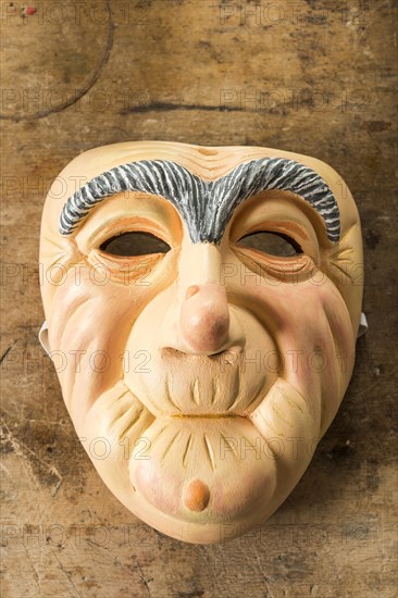 Painted wooden mask on a workbench