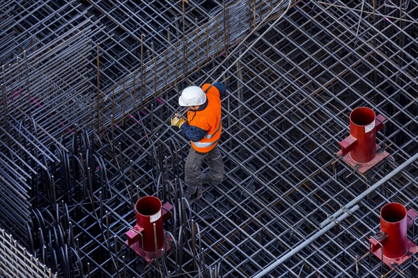 Construction workers processing reinforcing steel for reinforced concrete ceiling