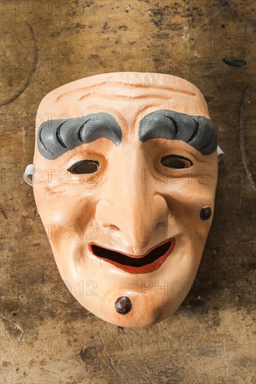 Painted wooden mask on a workbench